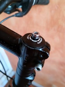 Serrez la vis au sommet de la potence. Il faut utiliser celle livrée avec le rehausseur, l'ancienne n'est plus assez longue