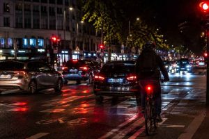 Visibilité du cycliste dans un carrefour urbain dense avec un éclairage fixe, essentiel pour être compris